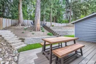 Relax or entertain on the deck overlooking a tranquil treed setting. Stairs up lead to an upper level.