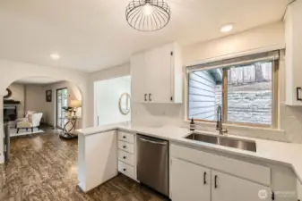 Off the kitchen is the family room, a slider to the deck, and access to the bonus room.