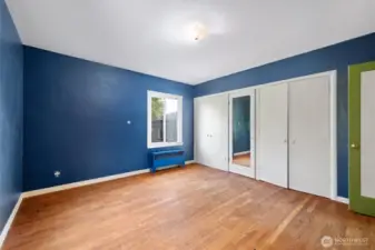 One of 2 main floor bedrooms, also with original hardwood floors.