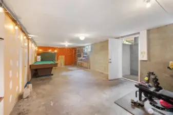 There is an additional unfinished space in the basement. Door on the right is to the outside with stairs up to the yard. Door on the left goes into the lower suite. This space could be storage, or finished for more living space.