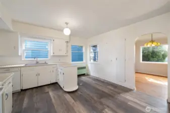 A large kitchen with updated vinyl plank flooring.