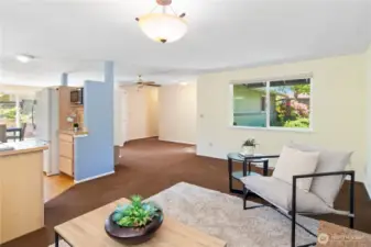 View from the fireplace to kitchen and entry door. Hallway leads to three bedrooms.