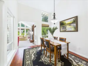 Spacious dining room with vaulted ceiling.