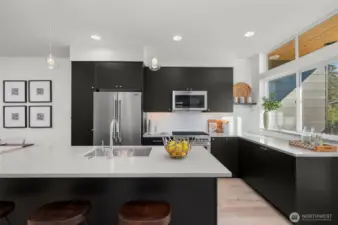 A closer look at the kitchen reveals a harmonious blend of sophistication and practicality. Enjoy the seamless flow of this space, ideal for cooking, entertaining, or simply admiring the thoughtful design. Photos of home with similar layout, finishes & fixtures.