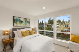 Bright and inviting, this third bedroom is a sanctuary filled with sunlight and charm. Overlooking the vibrant neighborhood, it's a picturesque space ready to personalize. Photos of home with similar layout, finishes & fixtures.