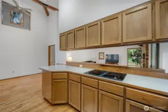 The galley kitchen is set up so that you can be cooking in the kitchen and watch the activity in the TV room