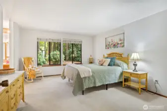 Primary bedroom with large window looking out to back yard