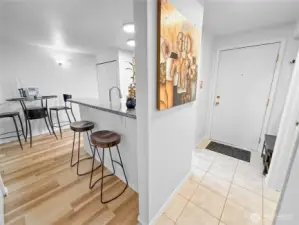 Here is a view of the kitchen, the dining room, and the eat-in bar, as seen from the bedroom doorway.