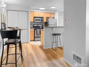The kitchen, dining room, and eat-in bar, as viewed from the corner of the living room.
