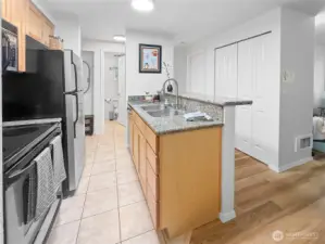 One more picture of the kitchen, this time from in front of the laundry closet.  The closet on the right side of the photo offers lots of storage space. The bedroom is just past that (with the door closed). The bathroom and entry are in the background on the left.