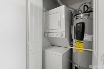 Stackable washer/dryer + new water heater. The kitchen is just to the right of this closet.