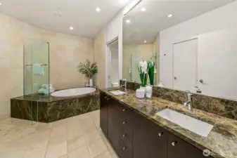 oversized soaking tub and shower double vanity and dedicated closet for more storage