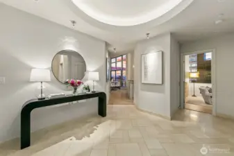 Entry features a circular light feature recessed with a marble landing in foyer