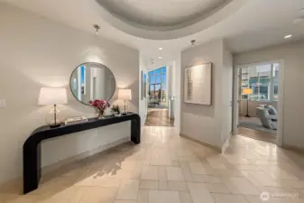 Entry features a circular light feature recessed with a marble landing in foyer