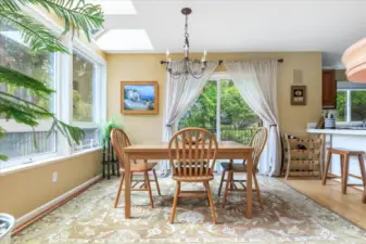 Dining room has slider to deck and big windows to bring in the views.