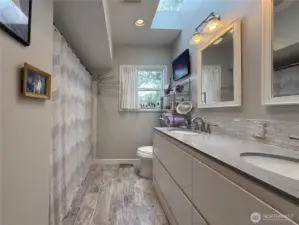 Full bath with dual vanity & lots of natural light.