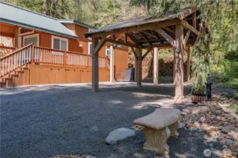 Generous covered parking enhanced by stunning rock and tree landscaping creates a perfect blend of function and beauty