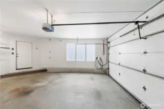 amenities, including an attached garage that accommodates parking for three vehicles and is equipped with an electric charger and a convenient bathroom—perfect for modern living.