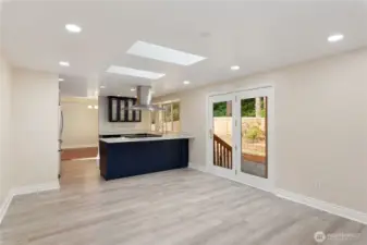 Unstaged view of family room and eat in kitchen