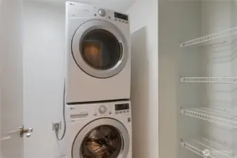 Stacked LG front load washer and dryer in laundry room