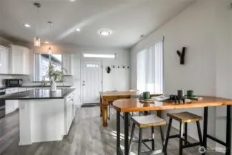 Looking back towards the front door, you can see more dining space and a beautiful kitchen!