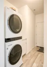 Entry from garage.  Stackable laundry with a folding table adjacent.