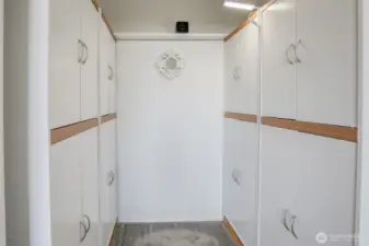 Walk in closet in the primary bedroom is nice and tidy with this closet system!