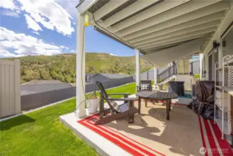 View of covered deck and lawn