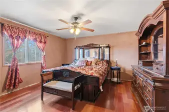 Primary Bedroom w/Ceiling Fan. Electrical Panel is to the Left of the Headboard.
