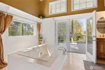 Primary bath is a dream with jetted tub and access to porch.