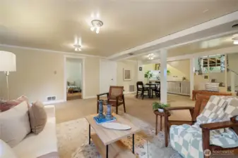 Lower Level space with partial kitchen and outlet for stove.