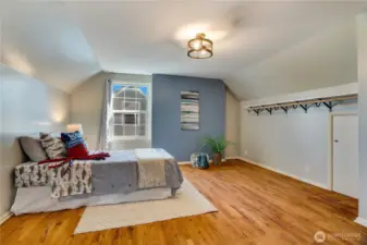 Take a right at the top of the stairs into this 4th bedroom on the east side of the house. Wood floors, built-ins, and a small closet finish this room.