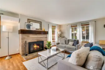 The house is heated by a gas furnace along with ductless mini-split units for heating and cooling. The wood-burning fireplace with its sturdy mantel is a cozy focal point for the room.