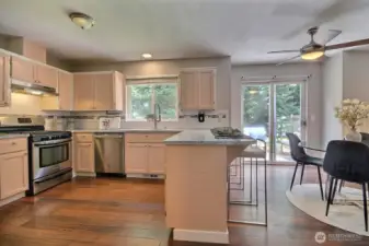 Light-filled kitchen with a convenient breakfast bar, stainless steel appliances and gas cooktop – perfect for casual meals or chatting with guests while you cook.