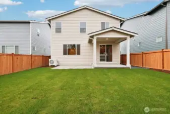 Fully fenced backyard with covered patio and extended slab.
