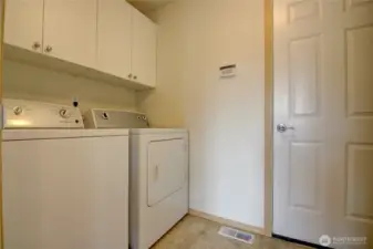 Laundy room showing entry door to garage