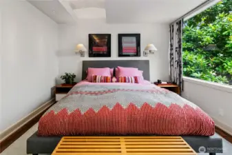 Awake to the quiet of Olmsted’s woodland, framed by windows that draw the forest inside. With two walk-in dressing rooms and direct access outdoors, the main-level owner’s suite is both convenient and secluded—its own private wing apart from daily life.