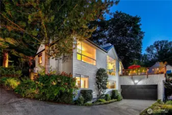 An integrated two-car garage is complemented by generous driveway space and guest parking above. Rare for a woodland setting, this Interlaken residence pairs parkland privacy with the everyday ease of ample parking.