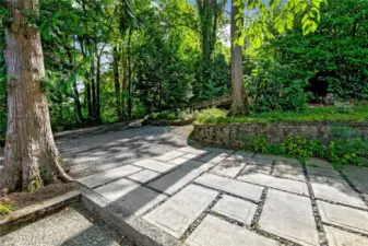 A broad stone-paved drive provides abundant parking for residents and guests alike. Rare in a woodland enclave, this ease of access pairs everyday practicality with the quiet setting of Interlaken Park.