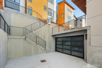 Possibly 2 parking stalls outside of the garage.