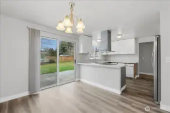 Glass Sliders Open To Large Fenced Backyard