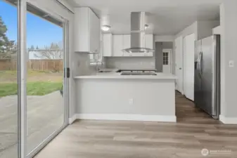 Open Kitchen Features New White Cabinets & New S.S.Hood Over Sleek Glass Stove Top