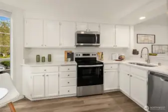 Thoughtfully updated kitchen features new stainless appliances and quartz countertops.