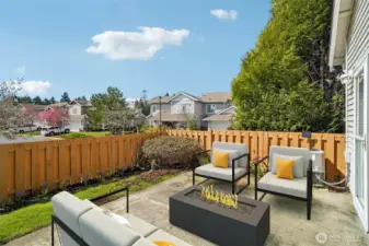 Virtual Staged - spacious back patio perfect for your summer gatherings and your green thumb too!