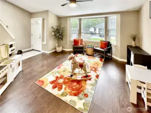 Living room with bay window and vaulted ceilings, just off of entry with skylight.  Enjoy laminate flooring throughout the entire home.