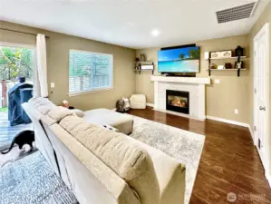 Family room is open to kitchen with gas fireplace to keep things cozy.