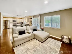 Another view of family room looking towards kitchen. Pantry to the left of island and slider to rear yard to the right.