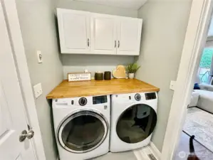Laundry room with cabinets, easy access from family/kitchen. Washer and Dryer included!