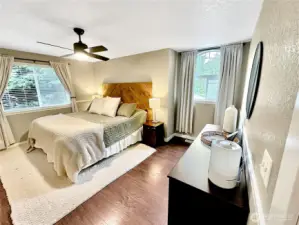 Generous primary with laminate flooring, ceiling fan and walk-in closet.