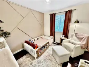 Second bedroom with sweet accent wall, laminate flooring too.